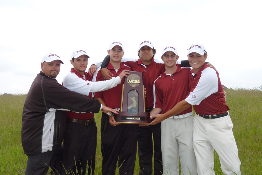Chico State Men's Golf stands in a row, each leaning in to touch trophy held by man in middle.