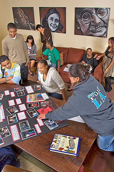 Student interactions inside the CCLC office; students in foreground collaborate on a project.