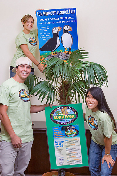 Three CADEC students hold signs to promote Fun Without Alcohol Fair. 