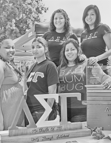 Five women stand strong representing sisterhood through a shared sorority affiliation.