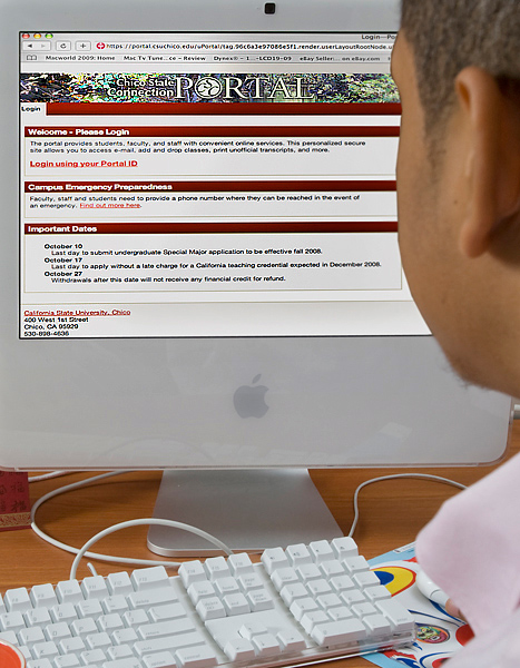 Over the shoulder shot of a man sitting at an Apple computer logging in to his Student Center via the Chico State University Portal.