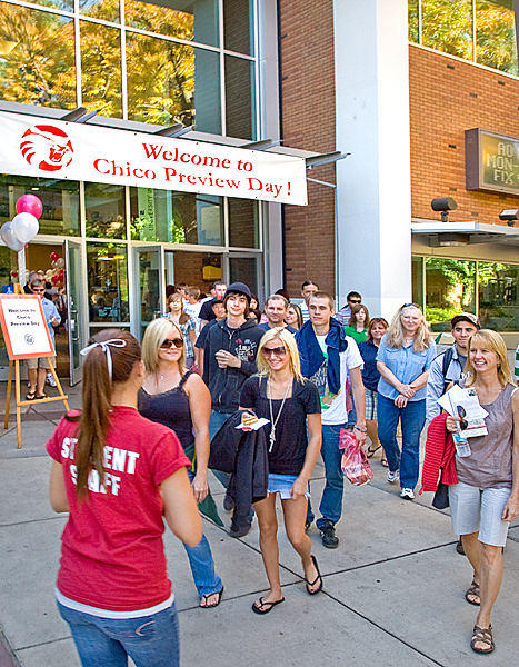 Female event staff member (left) leads a Chico Preview Day tour group out of BMU.