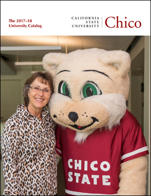 New CSU, Chico President, Gayle Hutchinson, poses with Willy the Wildcat inside the Student Services Center.  She wears a leopard print shirt while Willy...well, Willy has no pants.