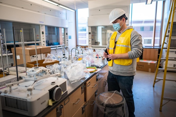 Creative Media and Technology Classroom Technology Services staff Derek Stanley installs projectors in the new science building.